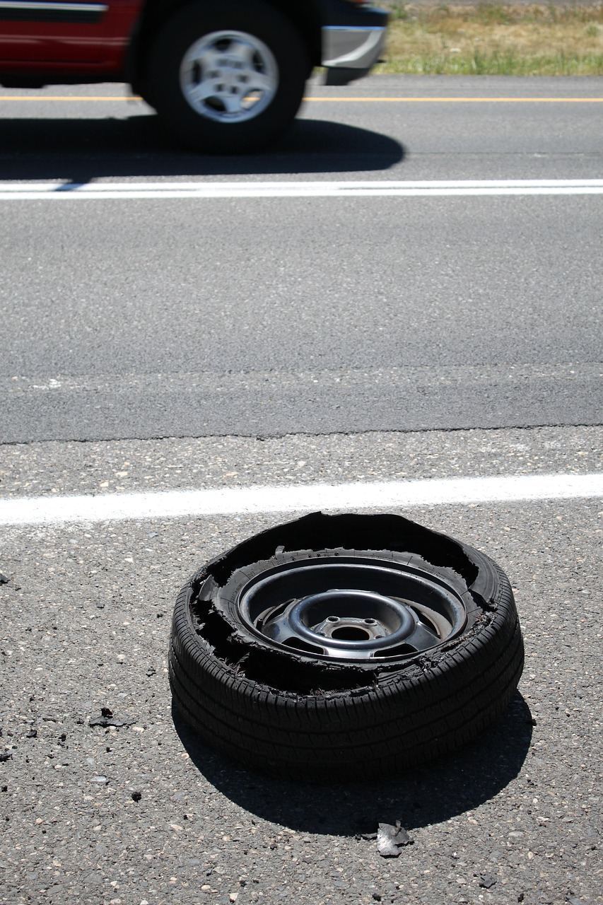 Flat tire blowout on the shoulder needing a temporary fix