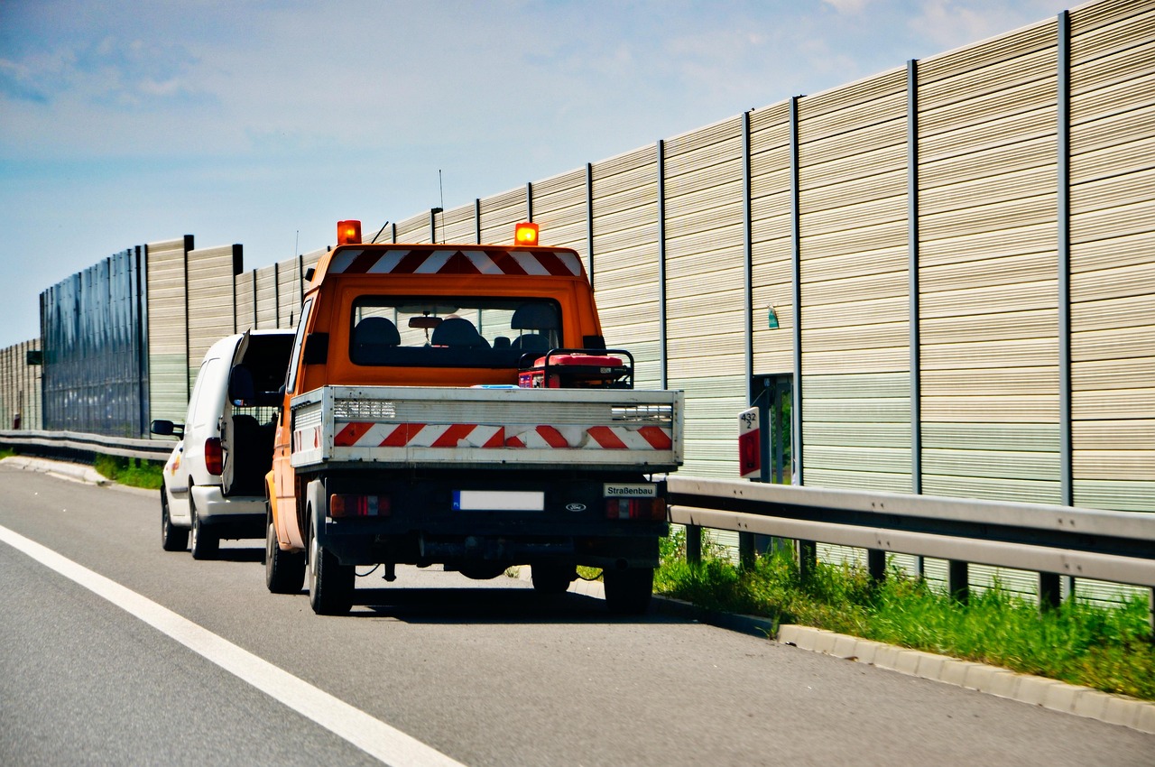 Service truck parked on a highway shoulder with hazard lights on